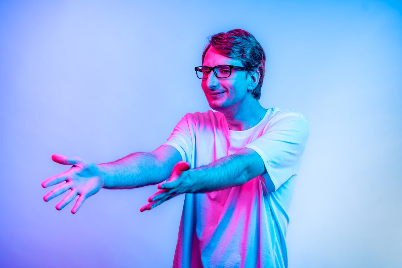 Man stretches arms to the left in front