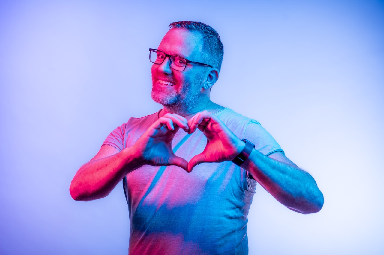 Man forms heart with his hands