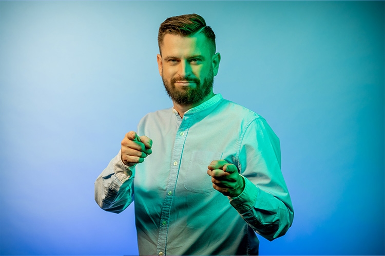 Man points forward with both index fingers 