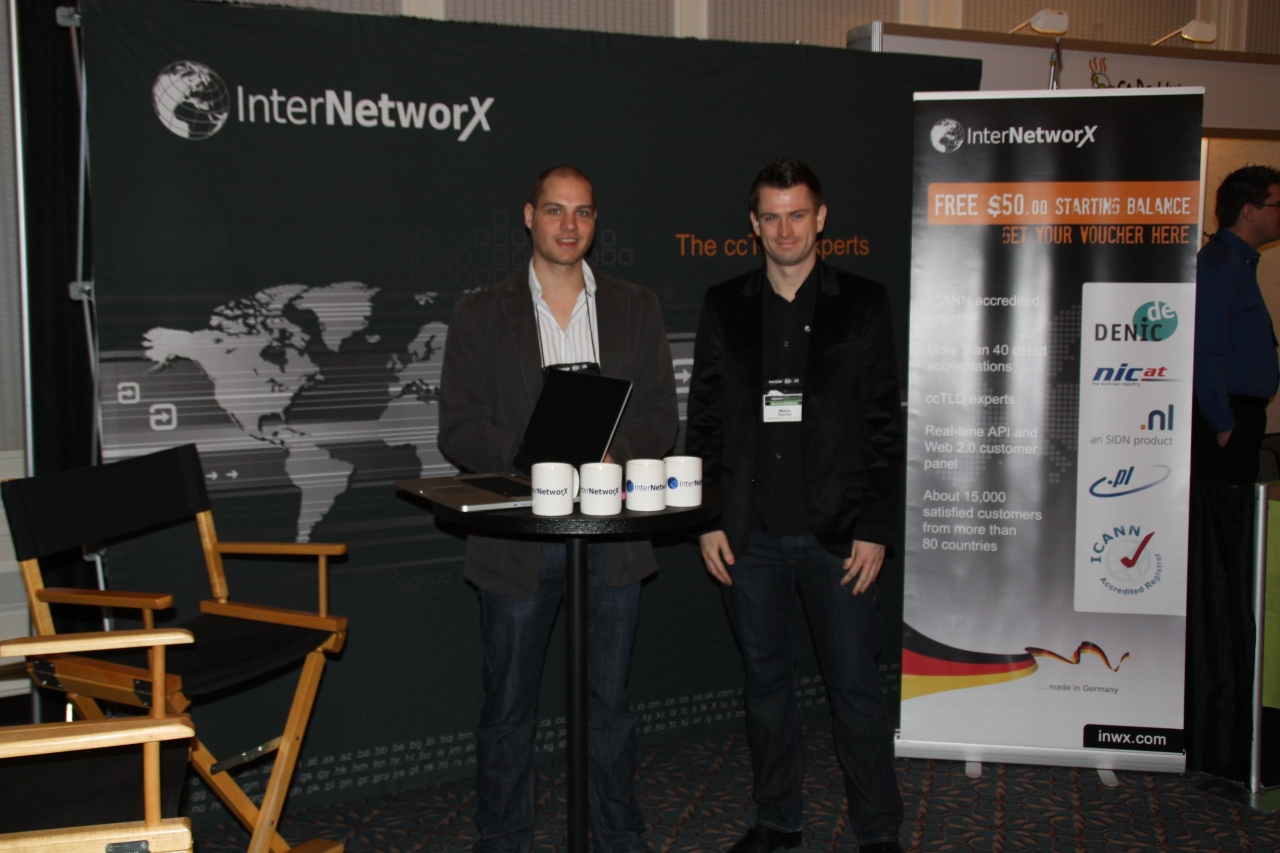 Two men stand in front of the InterNetworX booth