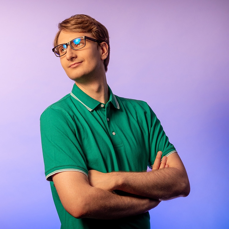 Man has his arms folded and is looking to the left