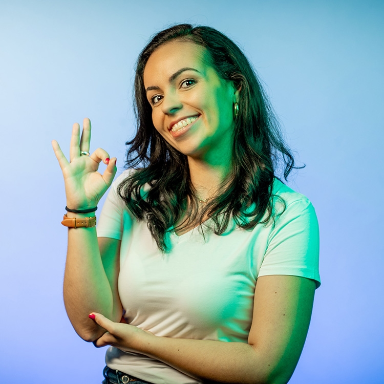 Woman points OK with index finger and thumb